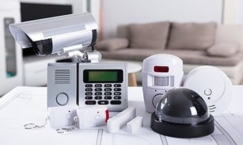 A Security System is Sitting on a Table in a Living Room — Electronic Security in Tweed, NSW
