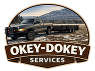 Gray pickup truck hauling a flatbed trailer in a field with a mountain backdrop. "Okey-Dokey Services" logo.