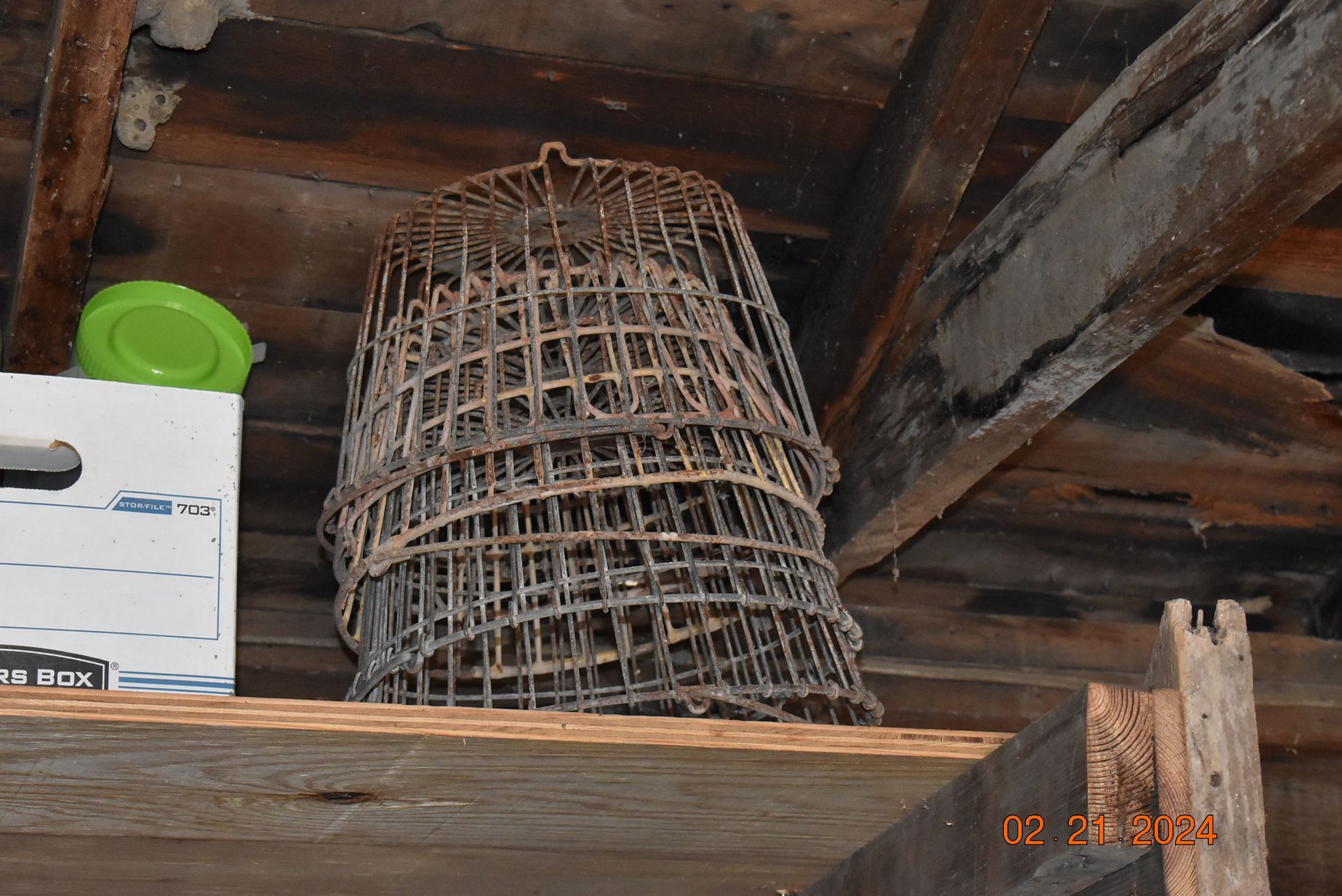 a stack of wire baskets sitting on top of a wooden shelf