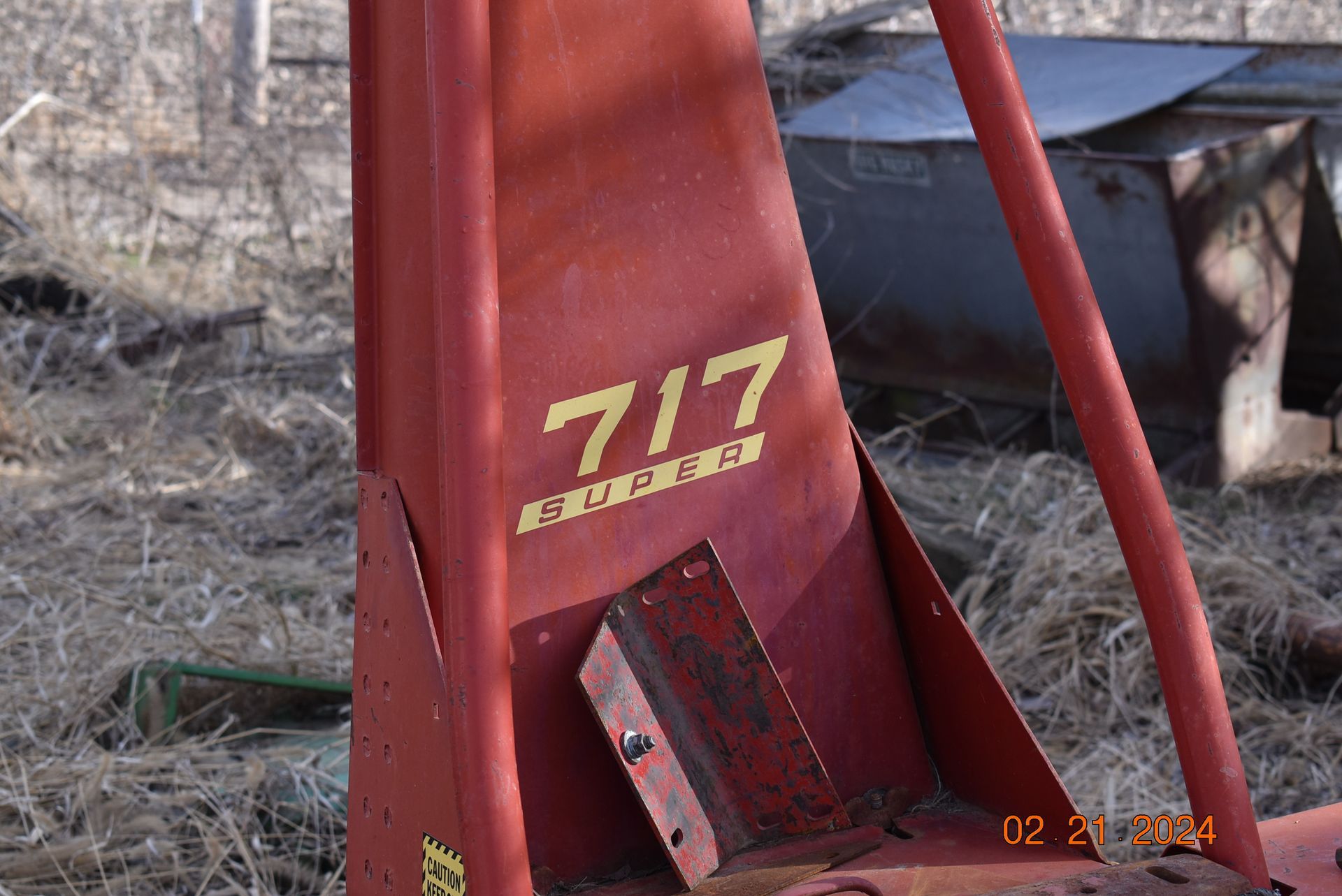 a red Holland tractor piece with the number 717 on it.