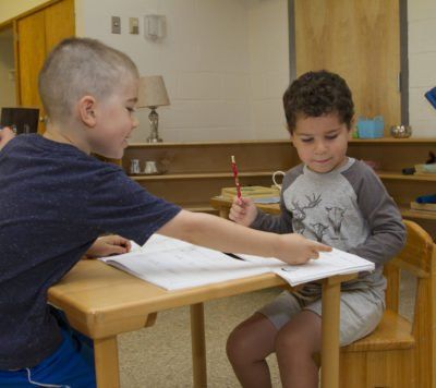 Montessori children working in the classroom 