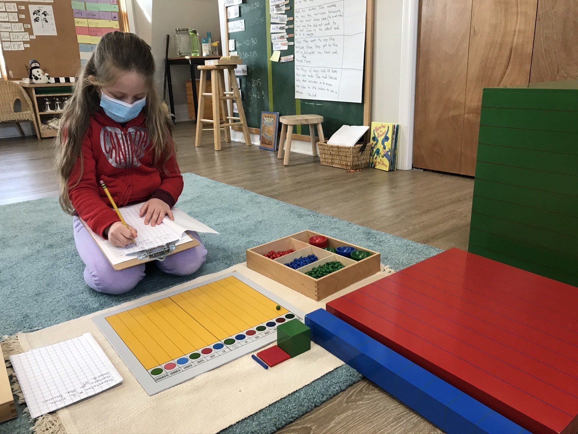Montessori child working with math materials 
