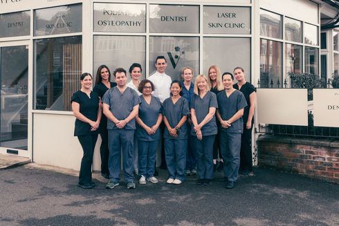 Medical staff posing in front of a clinic with 