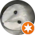 White owl with dark eyes and beak, an orange star badge in the corner.