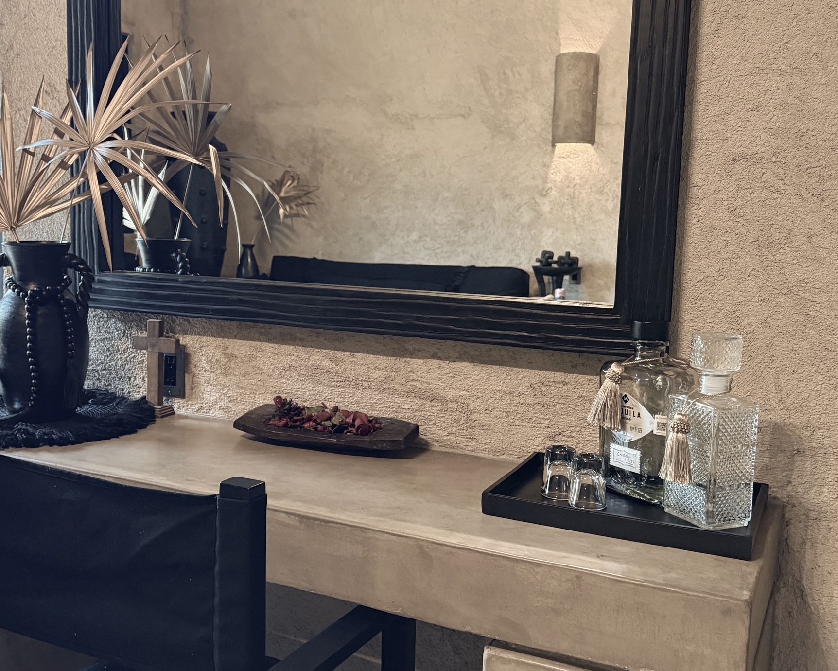 A desk with a mirror and a tray of drinks on it