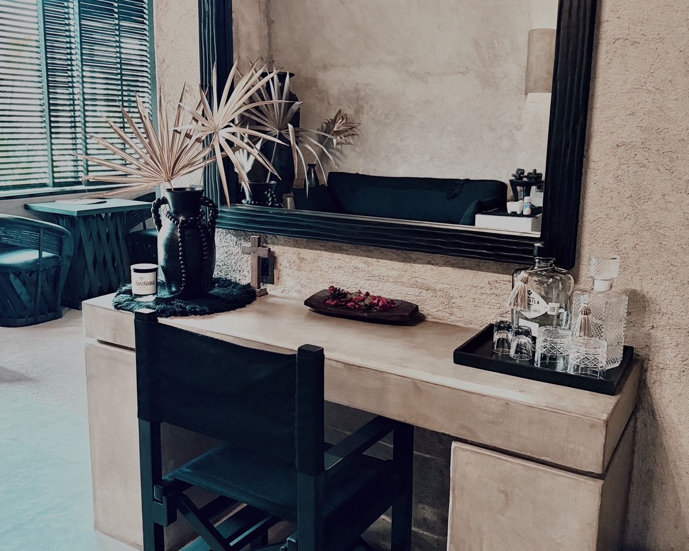 A desk with a chair and a mirror in a room