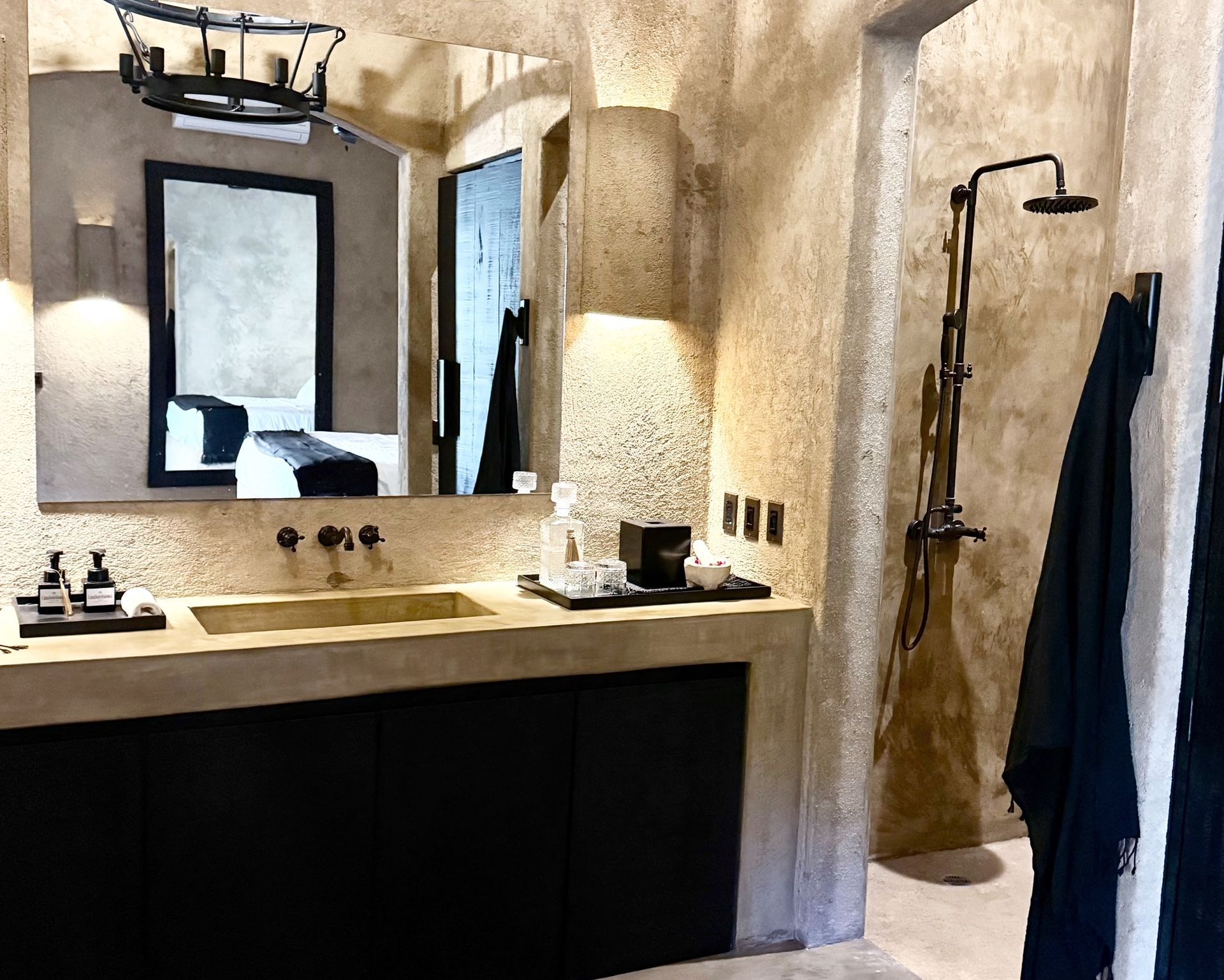 A bathroom with a sink , mirror and shower.