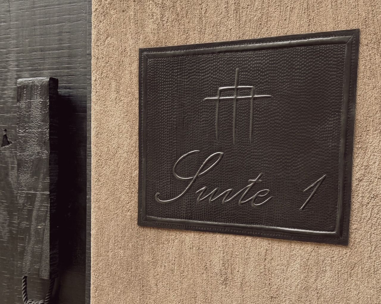 A sign on a wall that says suite 1