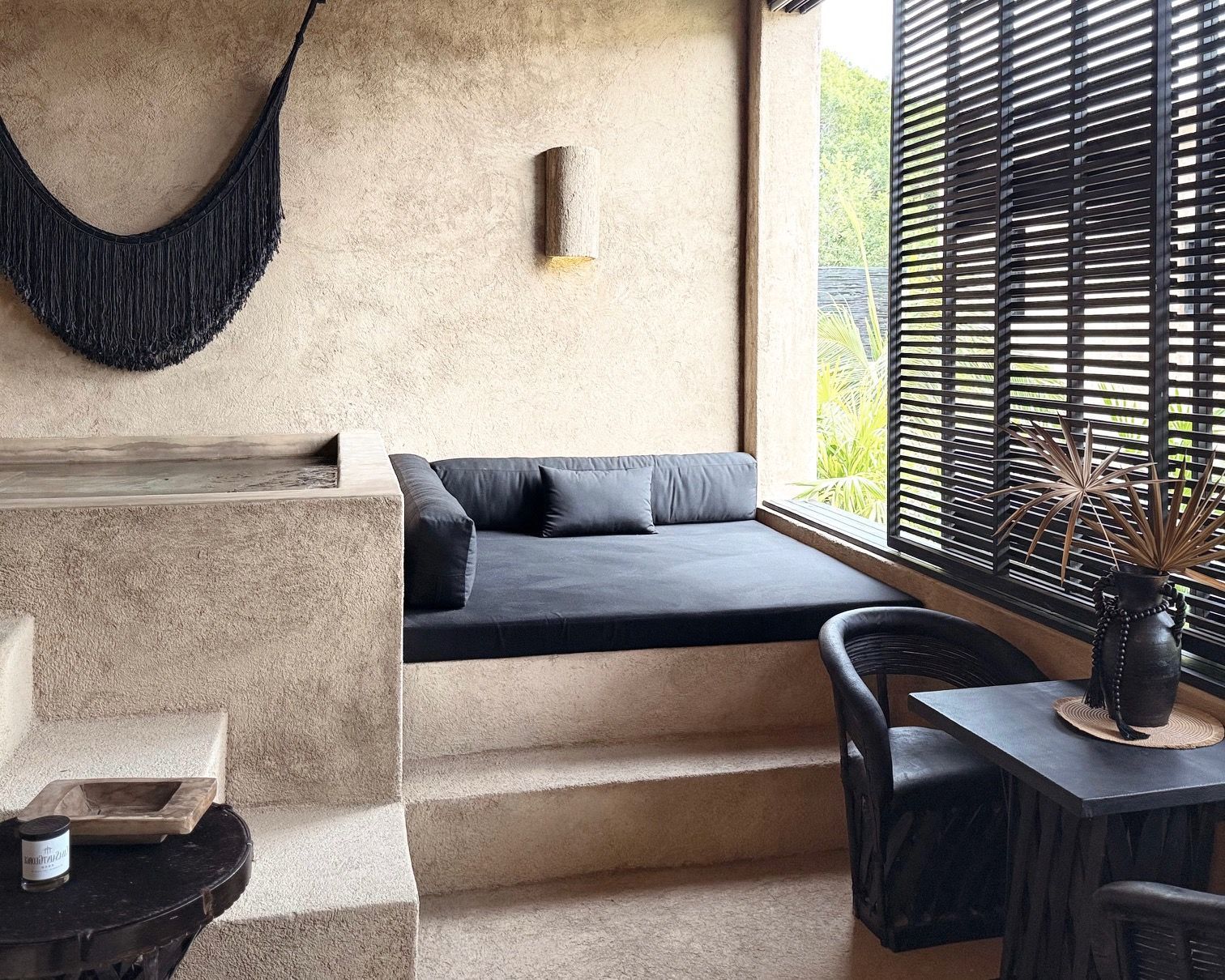 There is a hammock hanging from the wall in the living room.