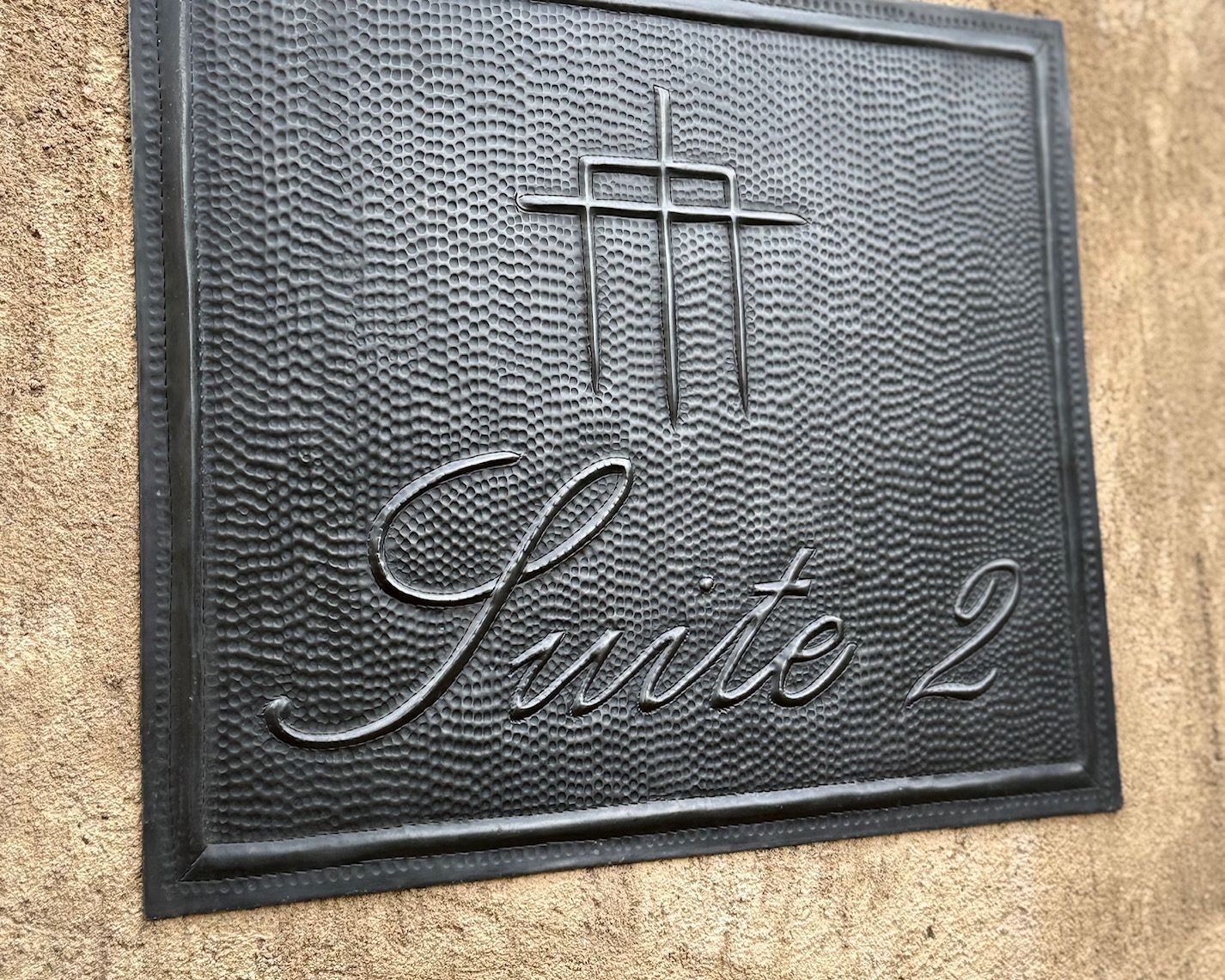 A black sign on a wall that says private 2