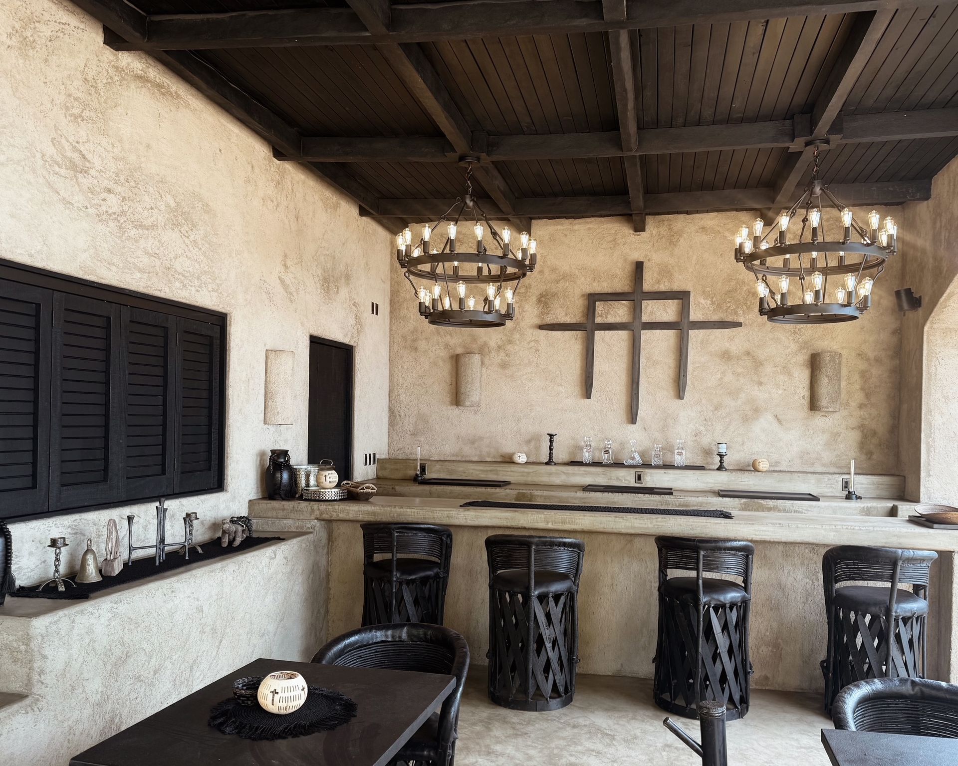 A room with a table and chairs and a cross on the wall