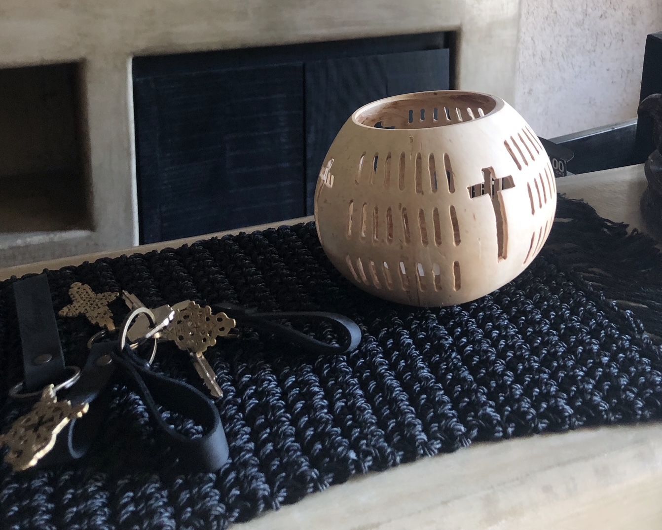 A candle holder with a cross carved into it