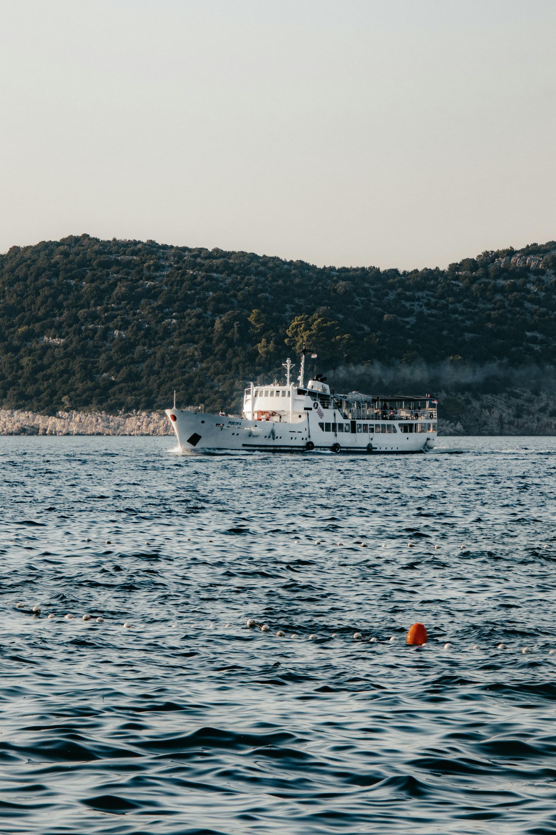 A boat is floating on top of a body of water.