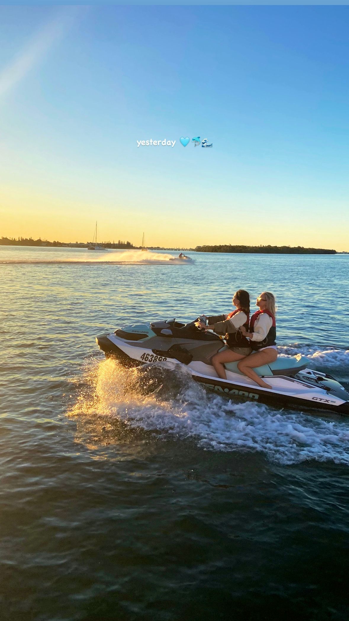 Two people are riding a jet ski in the ocean.