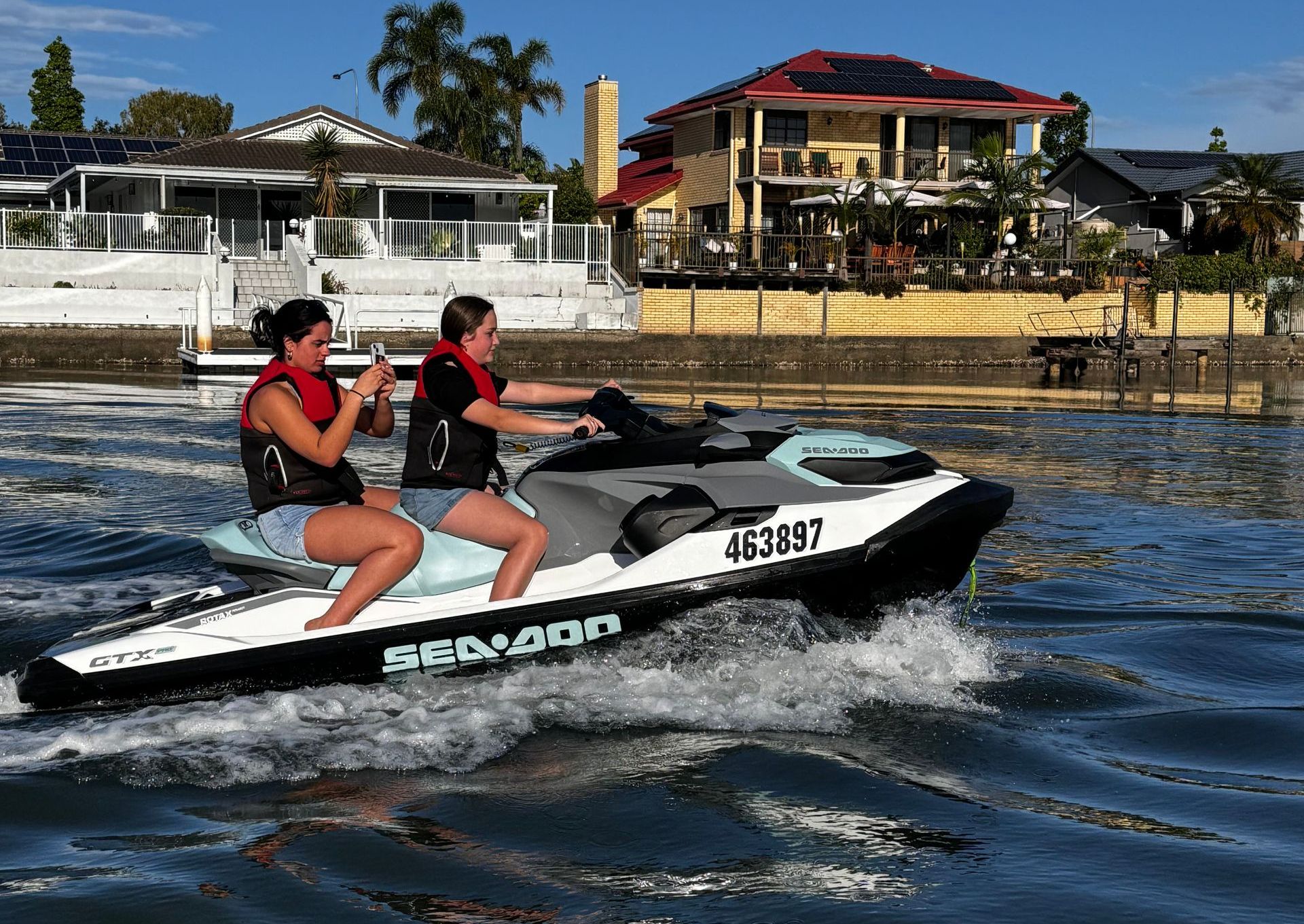 A group of people are riding jet skis on a lake.