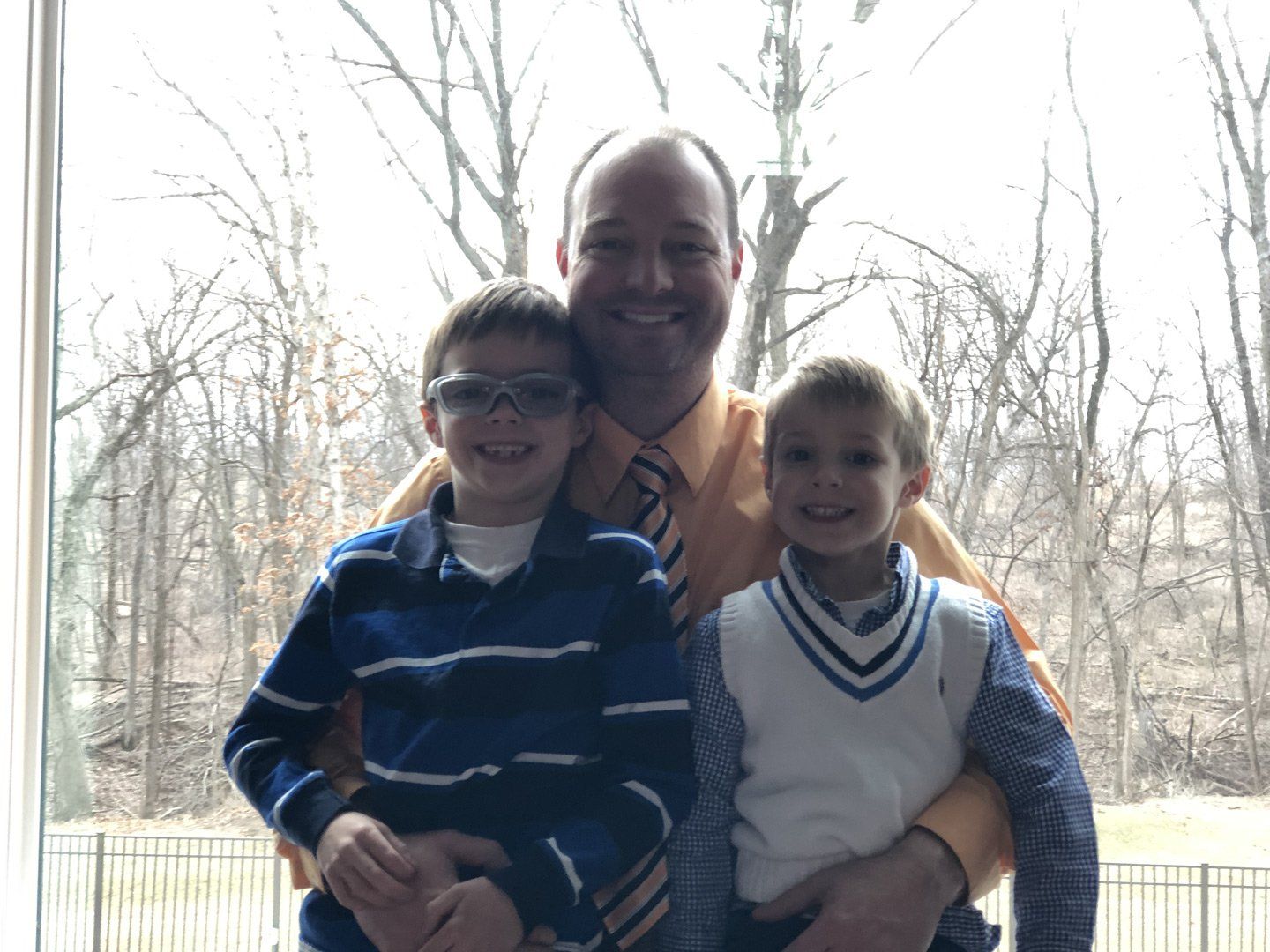 man and 2 kids smiling