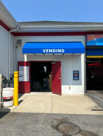 A building with a blue awning that says vending