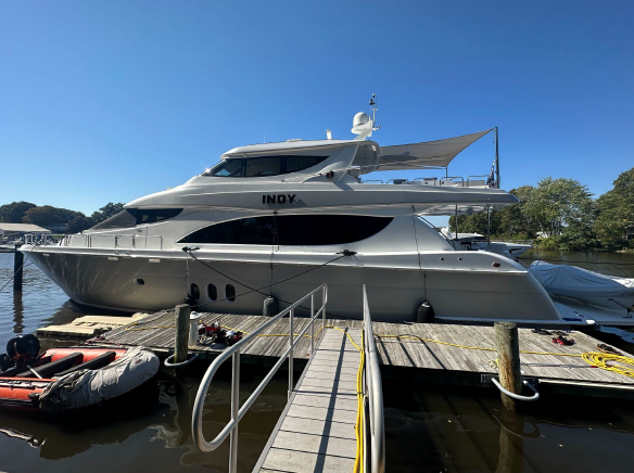 A large yacht is docked at a dock on a sunny day.