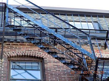 A fire escape on the side of a brick building