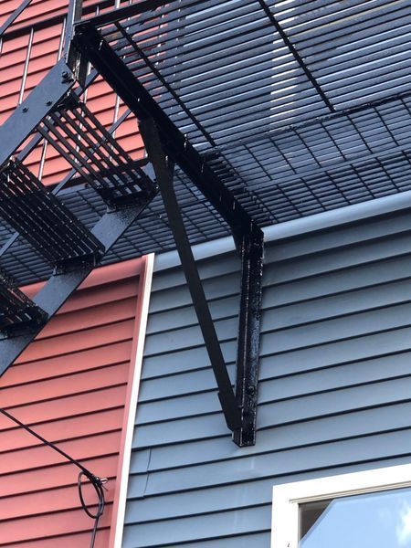 A fire escape is attached to the side of a building