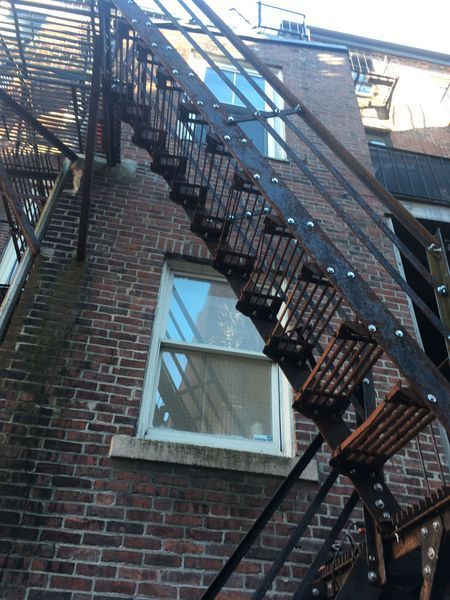 A fire escape on the side of a brick building