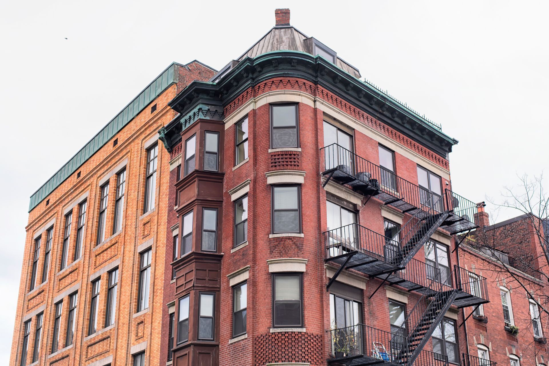 A brick building with a fire escape on the side of it.