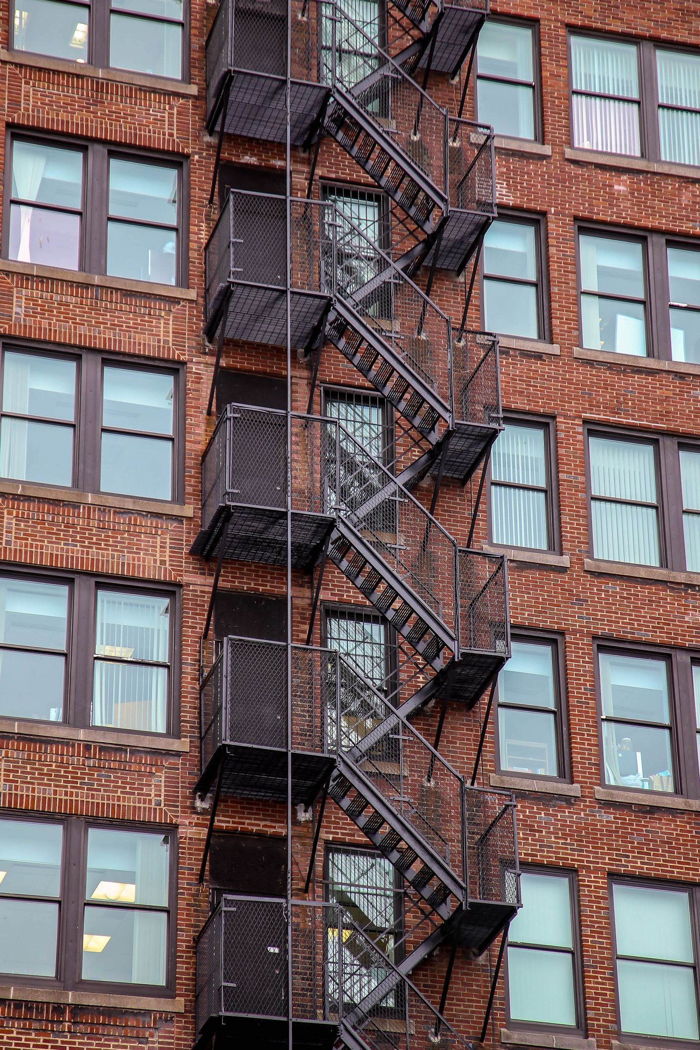 A brick building with a fire escape on the side of it.