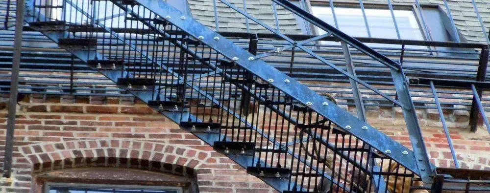 A fire escape on the side of a brick building.