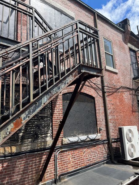 A fire escape on the side of a brick building