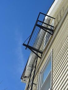 A fire escape is attached to the side of a building.