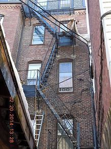 A fire escape on the side of a brick building