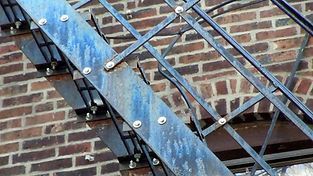 A fire escape on the side of a brick building.