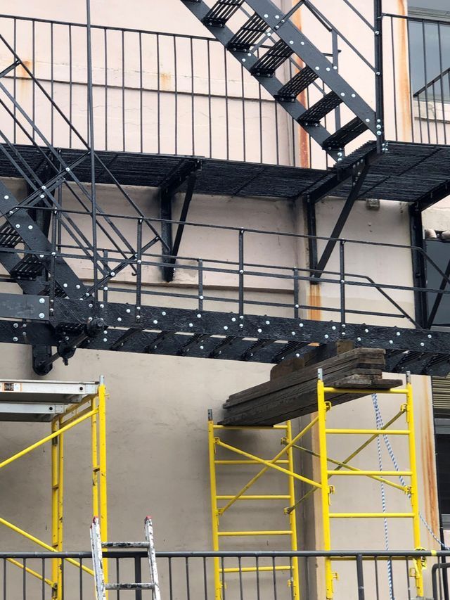 A fire escape is being built on the side of a building