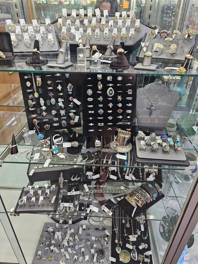 A display case filled with lots of jewelry in a store.