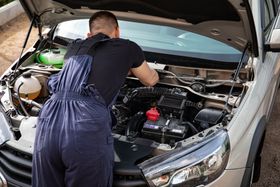 Technician Inspecting Vehicle Engine Components | Burtonsville Automotive Services