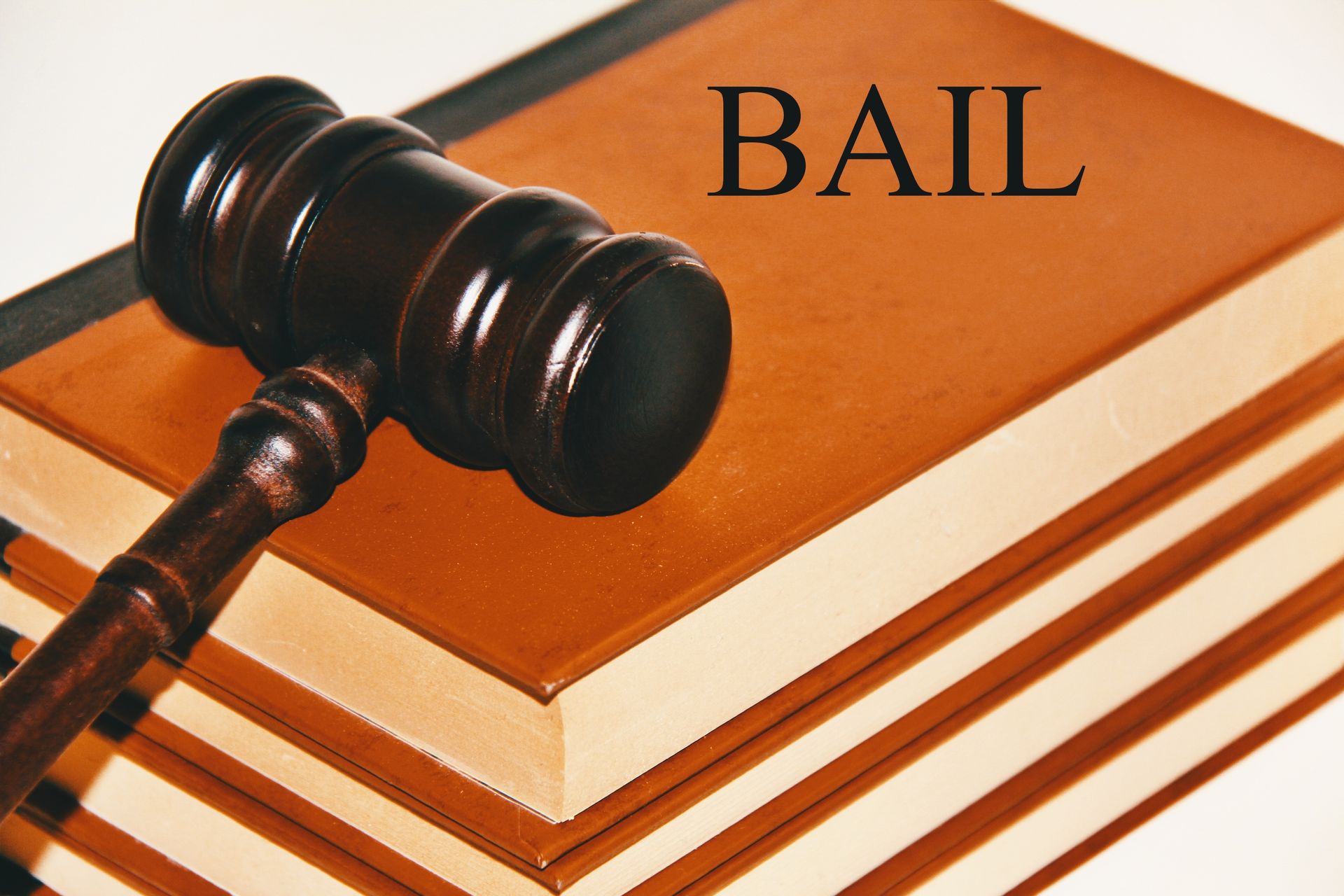 Judge’s gavel resting on law books labeled “Bail,” symbolizing legal proceedings. Judge’s gavel resting on law books labeled “Bail,” symbolizing legal proceedings.