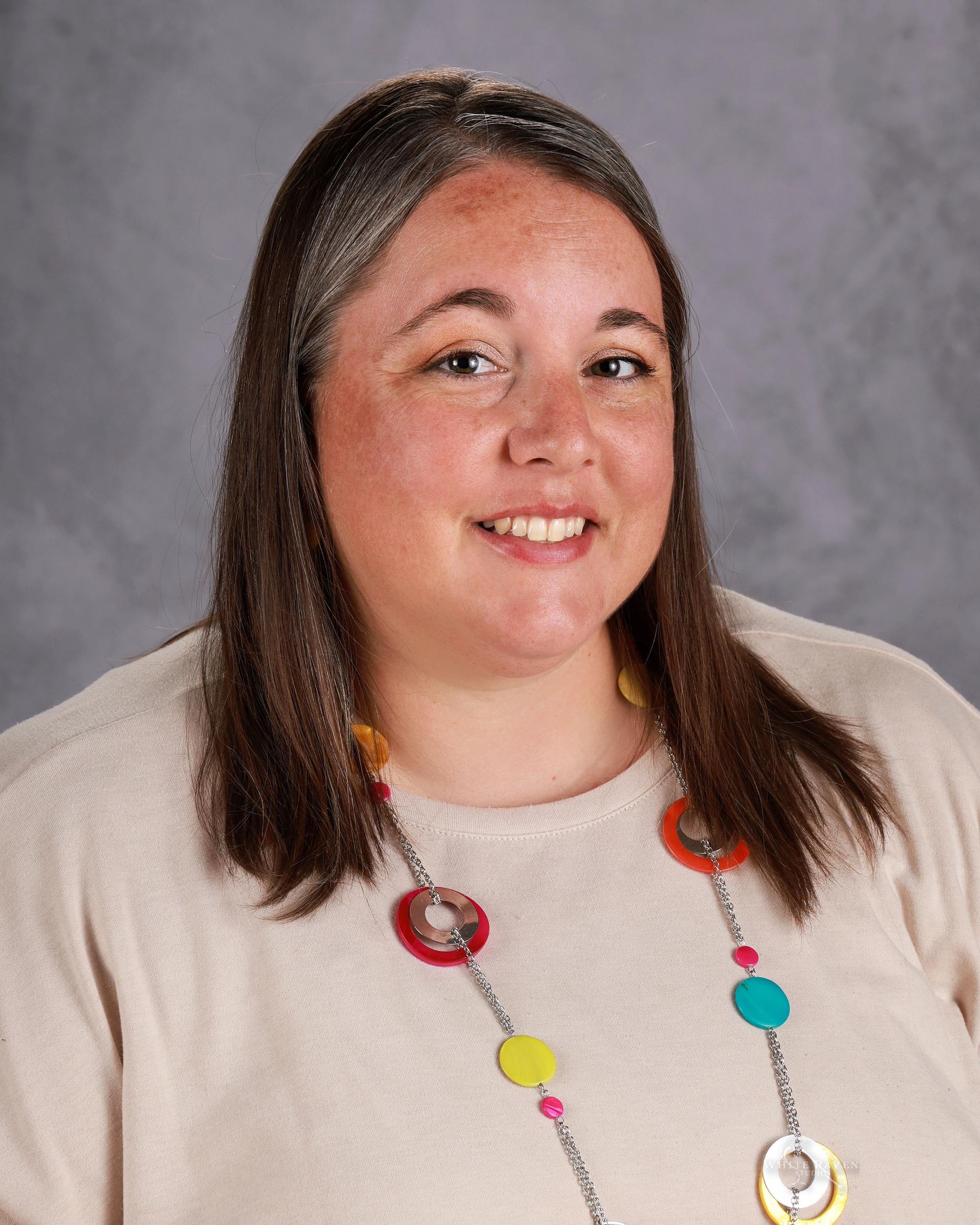 A woman in a black shirt is smiling for a picture.