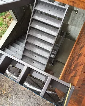 a set of stairs leading up to a basement under a house .
