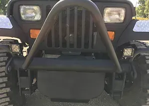 a black jeep is parked on the side of the road .