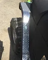 a close up of a jeep with a diamond plate fender .
