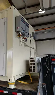 a large white container is sitting on top of a dumpster in a building .