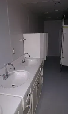 a bathroom with two sinks and a toilet .