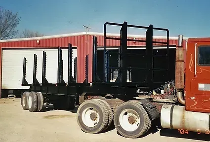 a red semi truck is parked in front of a red building