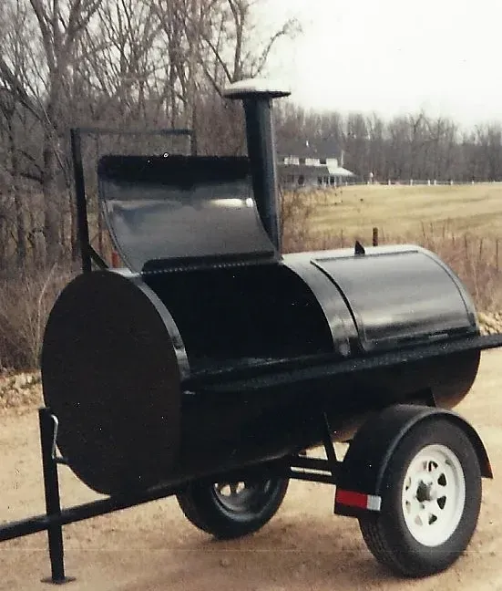 a black barrel on a trailer with the lid open
