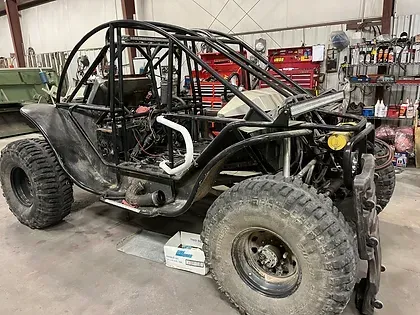 a buggy is being built in a garage .