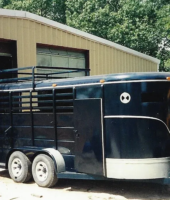 a horse trailer is parked in front of a building