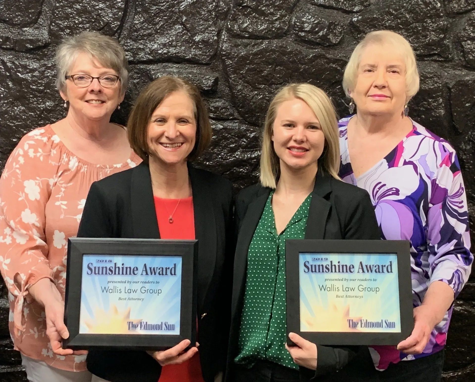 Four women are posing for a picture while holding sunshine awards.