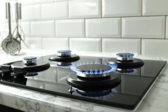 closeup shot of blue fire from domestic kitchen stove top