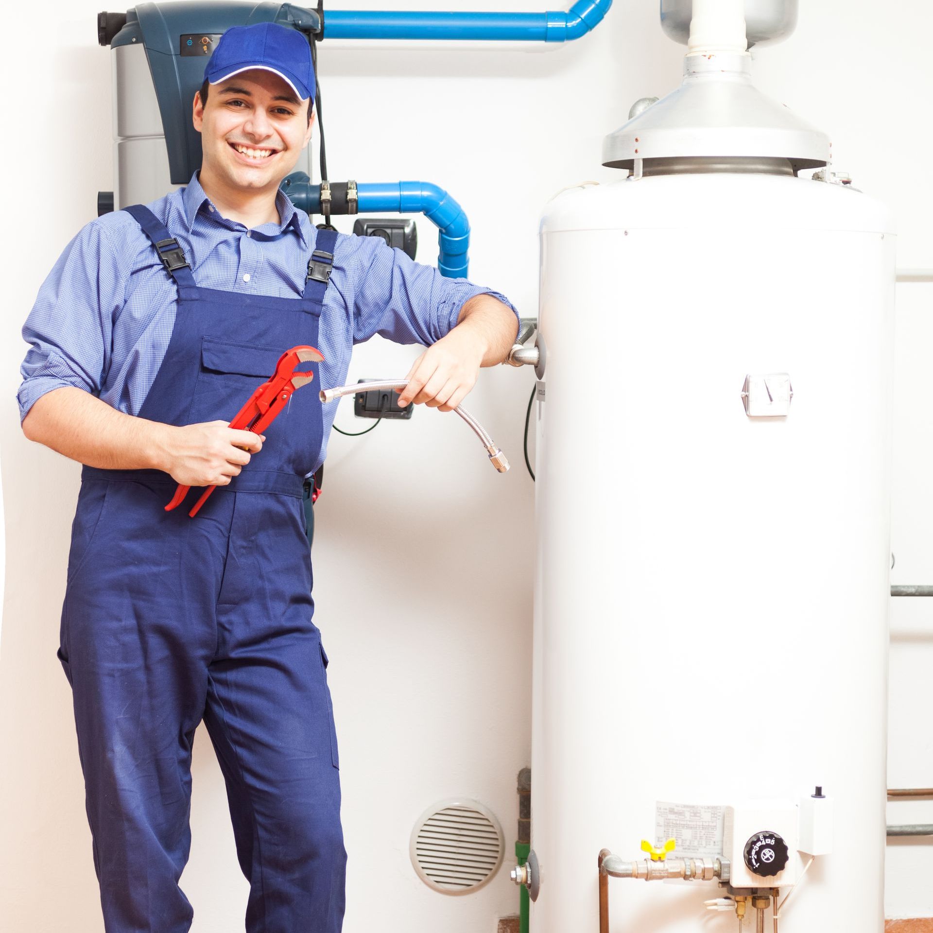 Smiling technician repairing an hot water tank