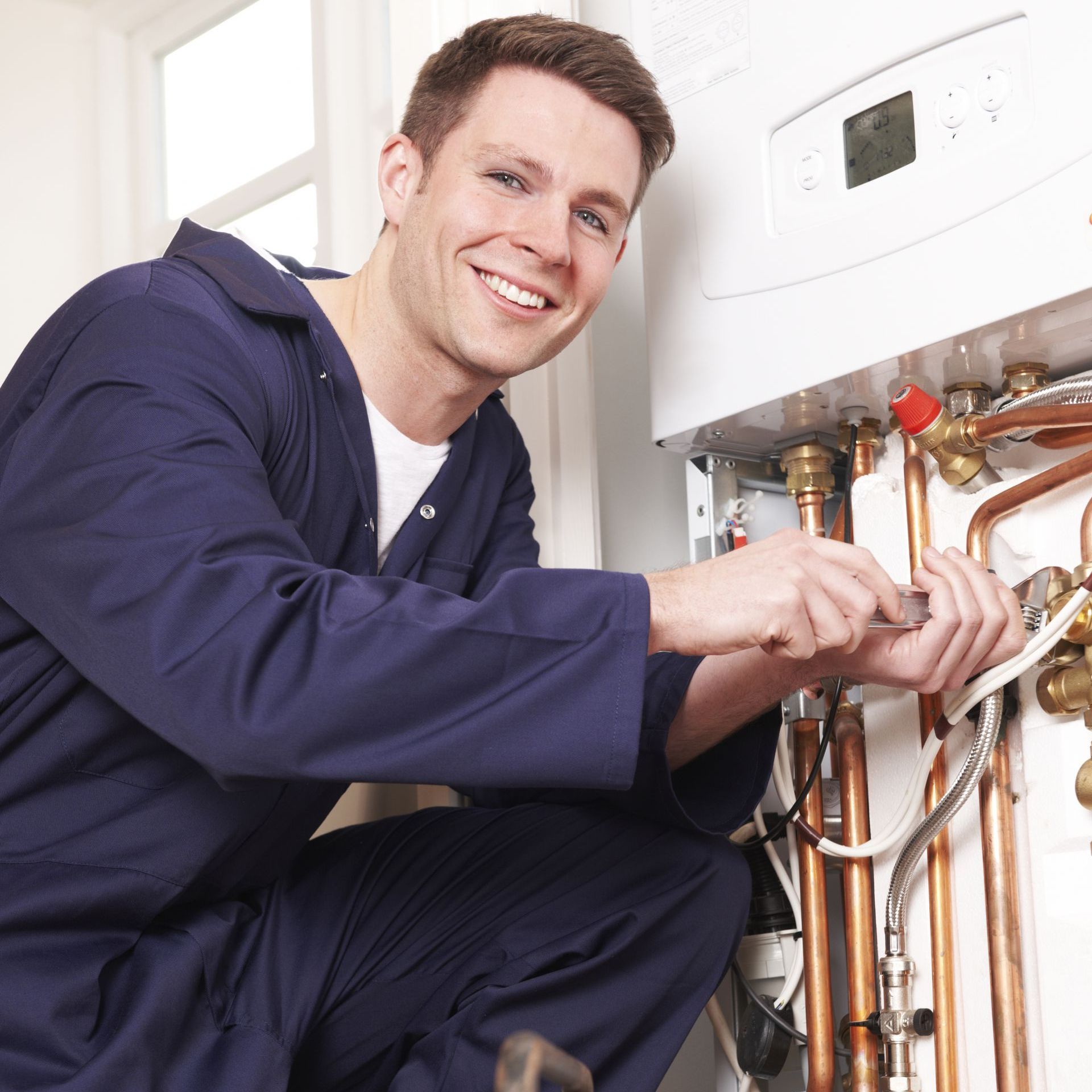 Engineer Servicing Central Heating Boiler